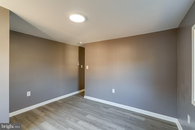 unfurnished room featuring wood finished floors and baseboards