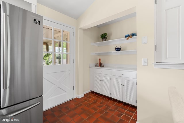 711 Clymer Ave, Sellersville, PA 18960 - doorway featuring baseboards, vaulted ceiling, and dark tile patterned flooring