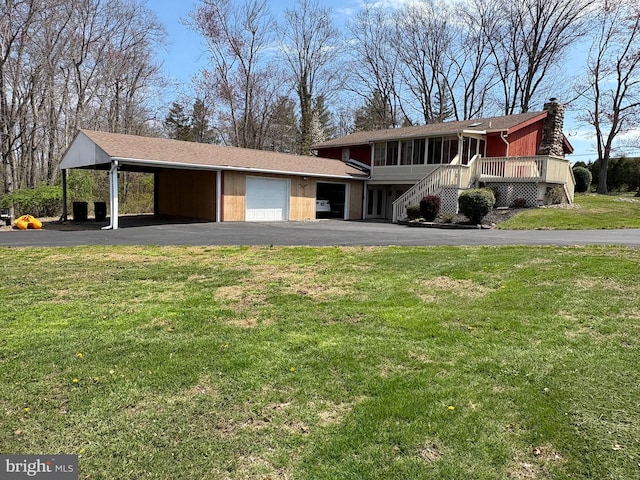 711 Clymer Ave, Sellersville, PA 18960 - view of front facade with a front lawn, driveway, a chimney, and an attached garage