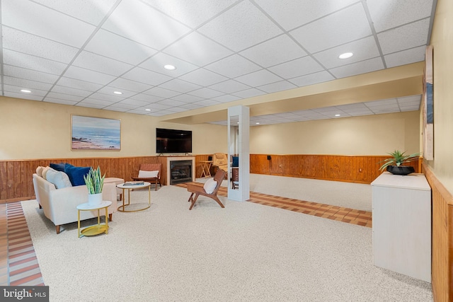 711 Clymer Ave, Sellersville, PA 18960 - living area with a wainscoted wall, wooden walls, a paneled ceiling, a fireplace, and carpet flooring