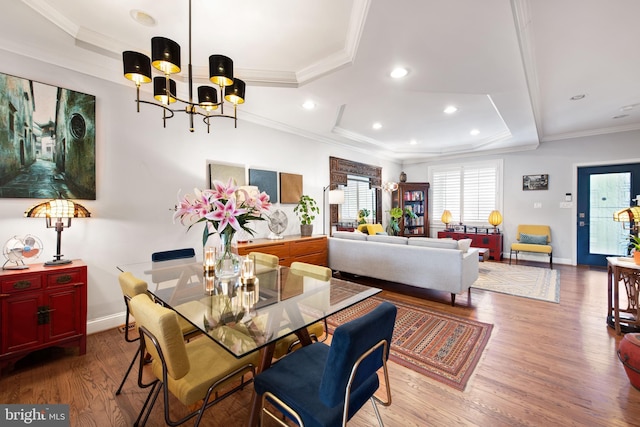 728 Farragut St NW, Washington, DC 20011 - dining area featuring crown molding, a raised ceiling, a chandelier, baseboards, and wood finished floors
