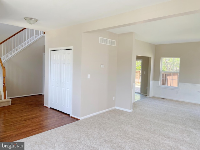 190 Wynnefield Rd, Bear, DE 19701 - carpeted spare room featuring visible vents, stairs, and wainscoting