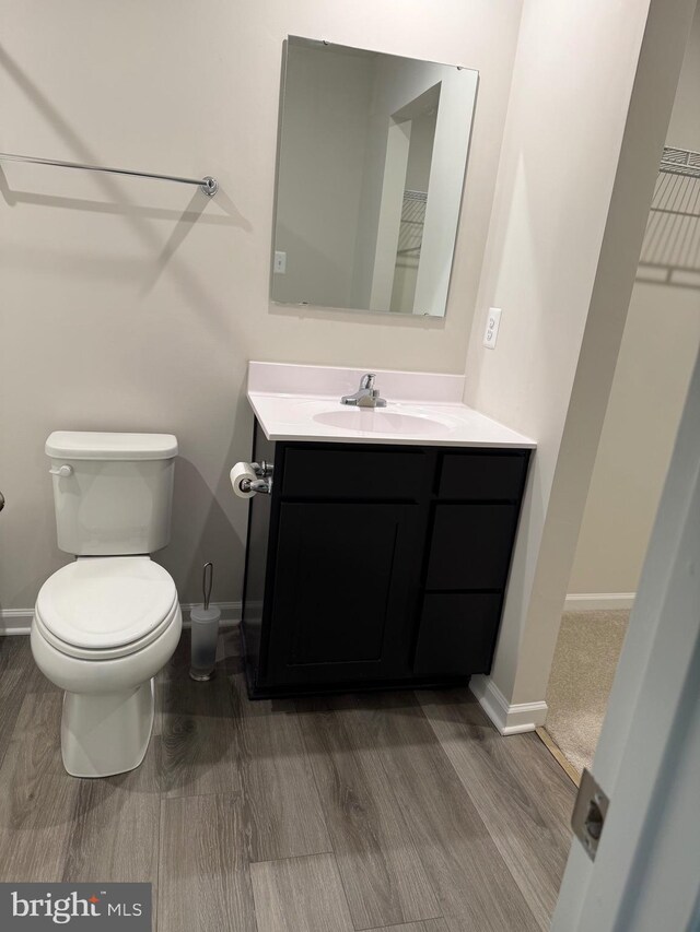506 Red Bill Ln, Cambridge, MD 21613 - bathroom featuring toilet, wood finished floors, vanity, and baseboards
