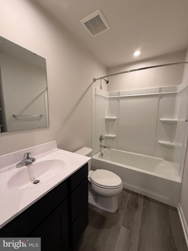 506 Red Bill Ln, Cambridge, MD 21613 - full bathroom featuring vanity, shower / bathing tub combination, toilet, visible vents, and wood finished floors