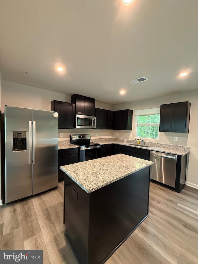 506 Red Bill Ln, Cambridge, MD 21613 - kitchen featuring a sink, a center island, visible vents, light stone counters, and appliances with stainless steel finishes