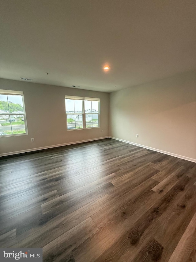 506 Red Bill Ln, Cambridge, MD 21613 - spare room featuring visible vents, plenty of natural light, dark wood-style floors, and baseboards
