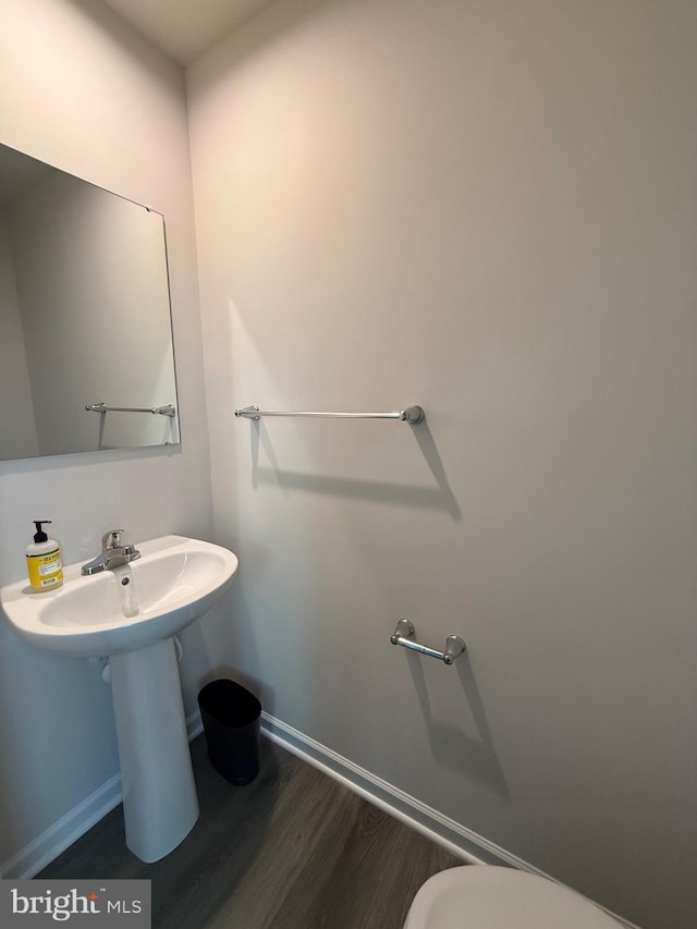 506 Red Bill Ln, Cambridge, MD 21613 - bathroom with wood finished floors, toilet, and baseboards
