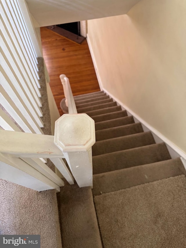 staircase with wood finished floors