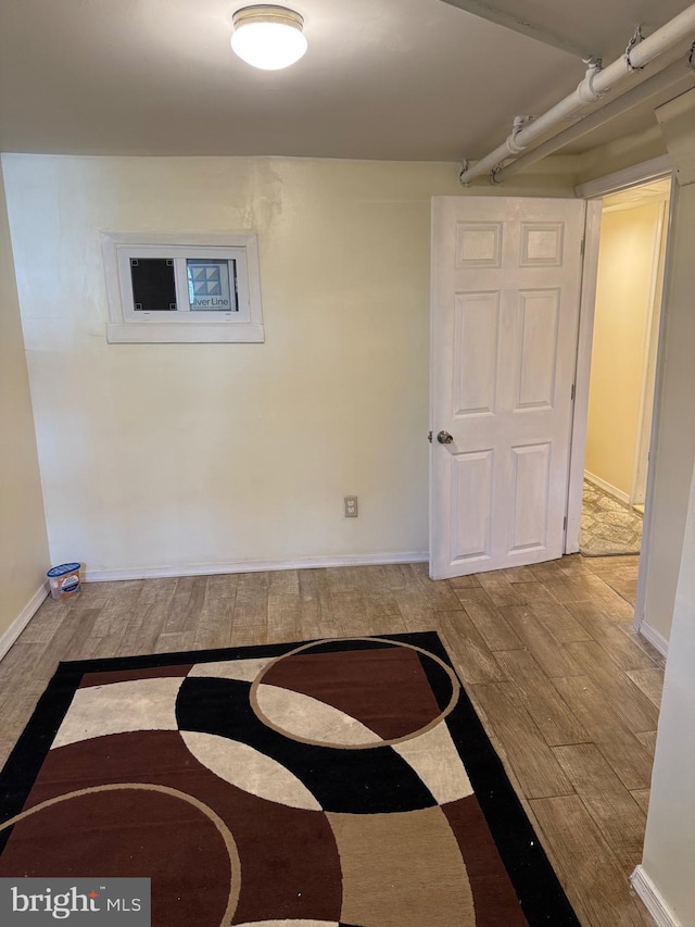 interior space with baseboards and wood finished floors