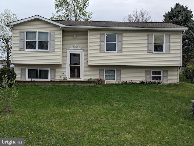 bi-level home with a front lawn