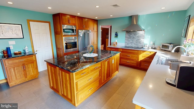 20 Eagle Ct, Gilbertsville, PA 19525 - kitchen featuring dark stone counters, wall chimney range hood, a center island, a sink, and appliances with stainless steel finishes