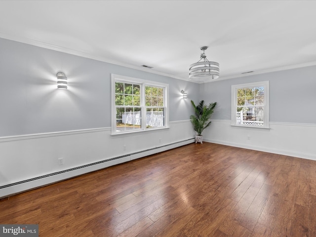 unfurnished room with hardwood / wood-style flooring, visible vents, a wainscoted wall, baseboard heating, and ornamental molding