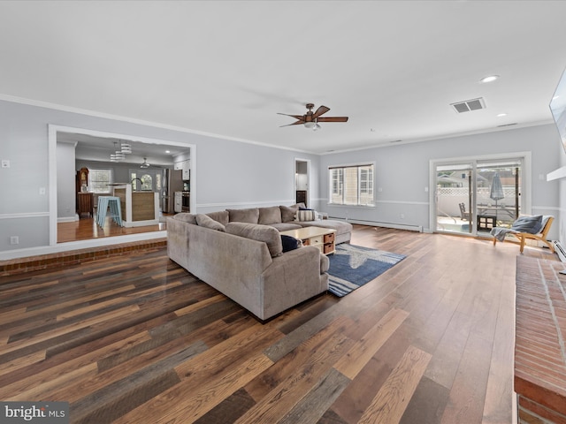 living room featuring crown molding, a ceiling fan, visible vents, and hardwood / wood-style floors