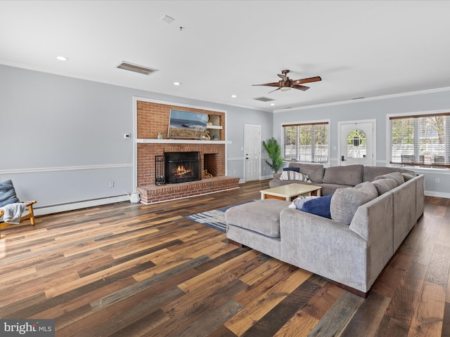 living area with recessed lighting, hardwood / wood-style flooring, ceiling fan, a fireplace, and visible vents