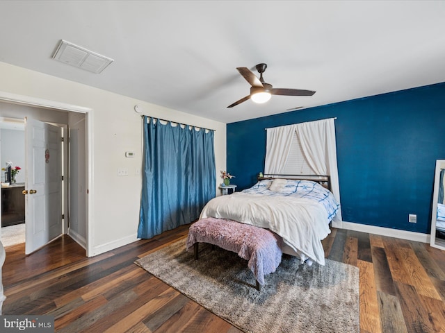 bedroom with wood finished floors, visible vents, a ceiling fan, and baseboards