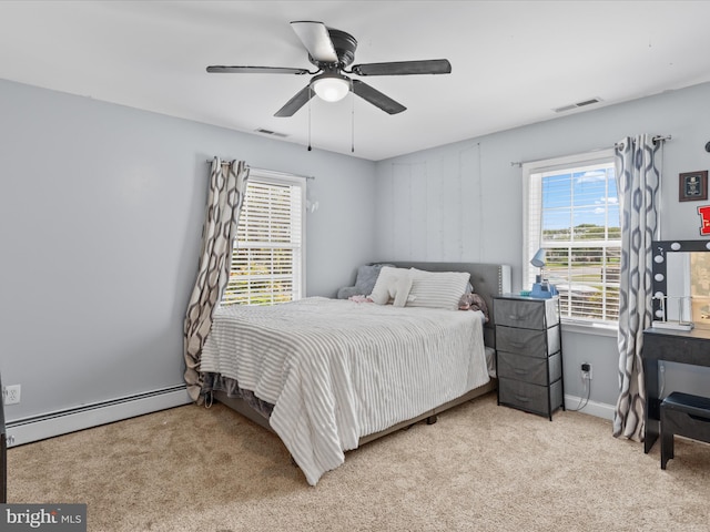 bedroom featuring visible vents, multiple windows, carpet floors, and a baseboard radiator