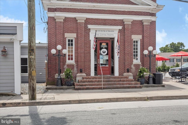 property entrance with brick siding