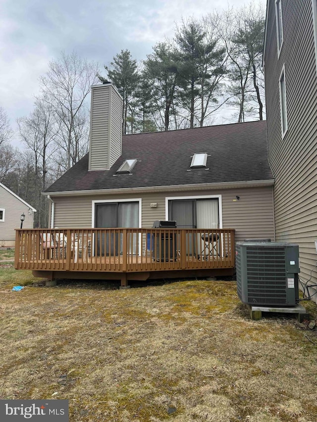 3322 Windermere Dr, Bushkill, PA 18324 - back of property featuring a chimney, roof with shingles, central air condition unit, and a deck