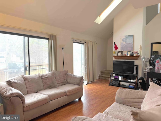 3322 Windermere Dr, Bushkill, PA 18324 - living room featuring lofted ceiling with skylight and light wood-type flooring