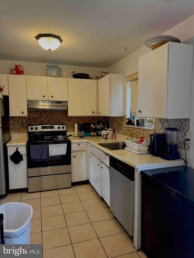 3322 Windermere Dr, Bushkill, PA 18324 - kitchen with under cabinet range hood, stainless steel appliances, light countertops, a sink, and white cabinetry