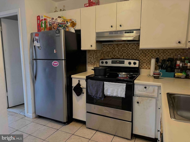 3322 Windermere Dr, Bushkill, PA 18324 - kitchen with stainless steel appliances, tasteful backsplash, light tile patterned flooring, light countertops, and under cabinet range hood