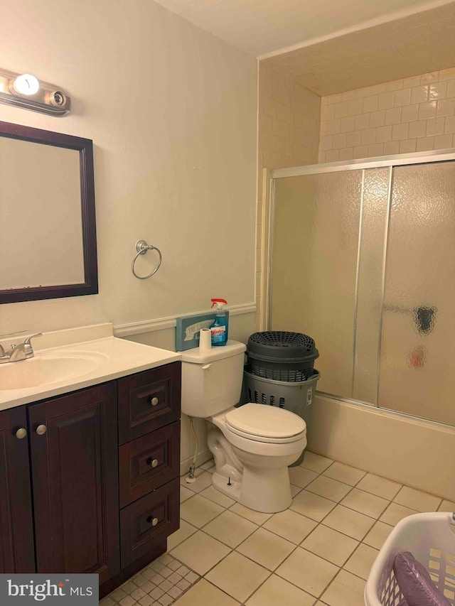 3322 Windermere Dr, Bushkill, PA 18324 - bathroom with vanity, toilet, tile patterned flooring, and combined bath / shower with glass door