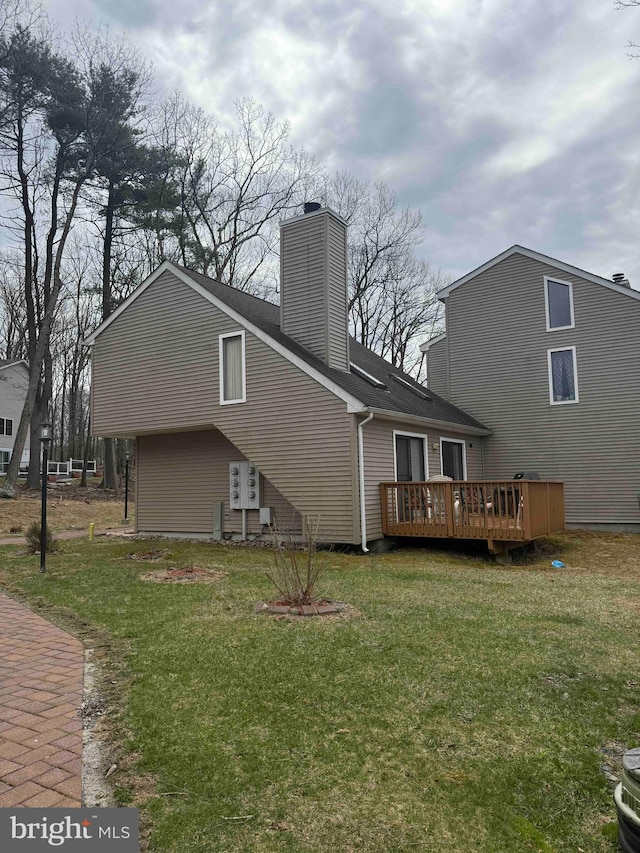 3322 Windermere Dr, Bushkill, PA 18324 - back of house featuring a lawn, a wooden deck, and a chimney