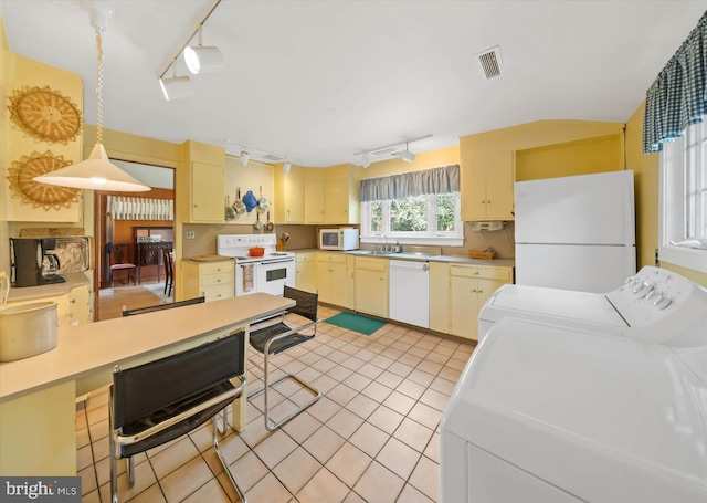 kitchen with white appliances, rail lighting, visible vents, light countertops, and washing machine and dryer
