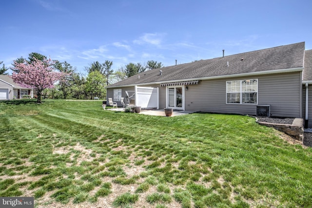 rear view of house with a yard, central AC, and a patio