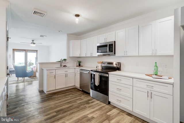 kitchen with white cabinets, appliances with stainless steel finishes, and a sink