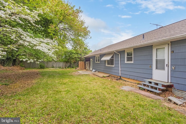 view of yard with fence and entry steps