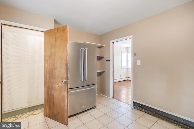 kitchen featuring a baseboard heating unit, open shelves, high end refrigerator, and light tile patterned floors
