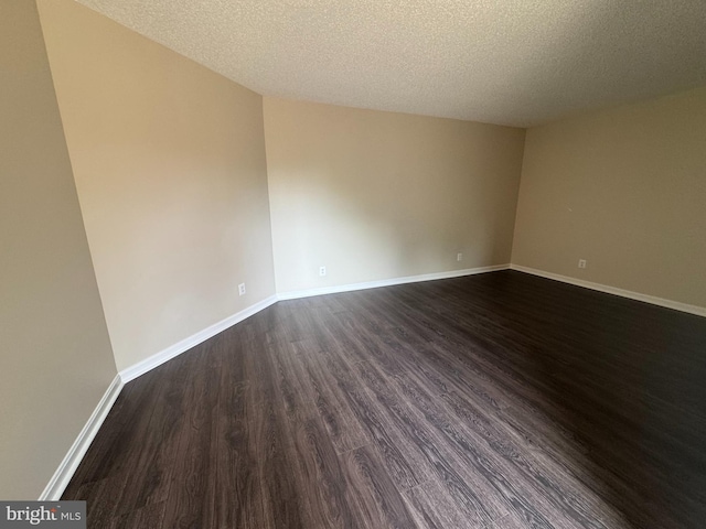 803 N Howard St Unit 435, Alexandria, VA 22304 - empty room with dark wood-style floors, baseboards, and a textured ceiling