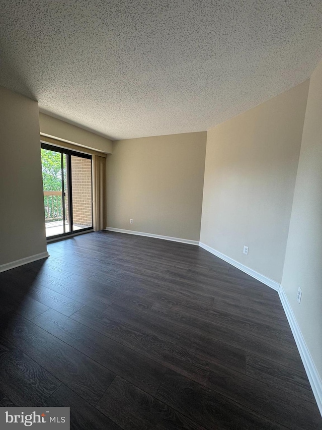 803 N Howard St Unit 435, Alexandria, VA 22304 - empty room with dark wood-type flooring, baseboards, and a textured ceiling