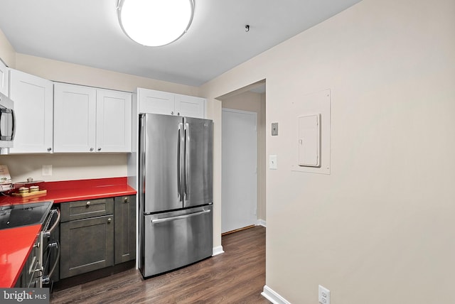 803 N Howard St Unit 435, Alexandria, VA 22304 - kitchen with appliances with stainless steel finishes, white cabinetry, dark wood finished floors, and baseboards