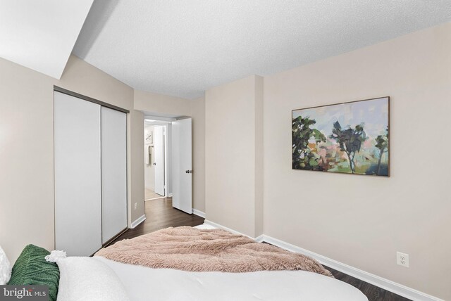 803 N Howard St Unit 435, Alexandria, VA 22304 - bedroom with a closet, baseboards, and dark wood finished floors