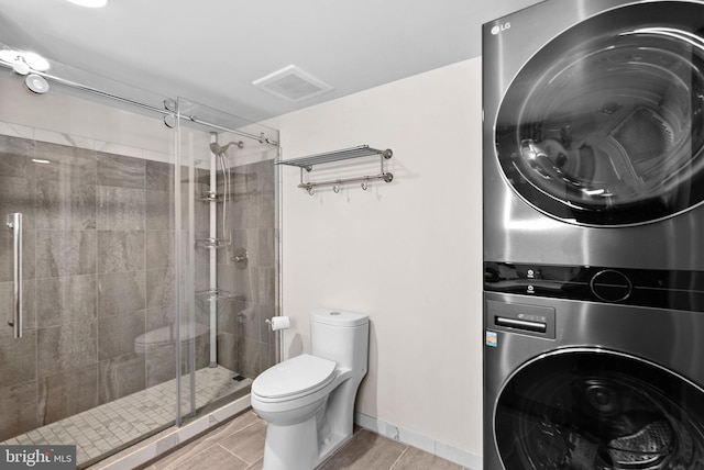803 N Howard St Unit 435, Alexandria, VA 22304 - full bath featuring stacked washing machine and dryer, toilet, and a shower stall