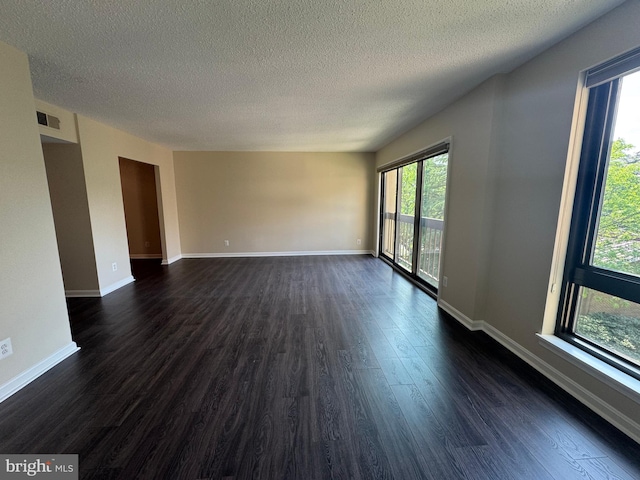 803 N Howard St Unit 435, Alexandria, VA 22304 - empty room featuring dark wood-style flooring, a textured ceiling, and baseboards