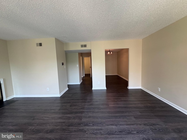 803 N Howard St Unit 435, Alexandria, VA 22304 - unfurnished room with dark wood finished floors, a textured ceiling, and baseboards