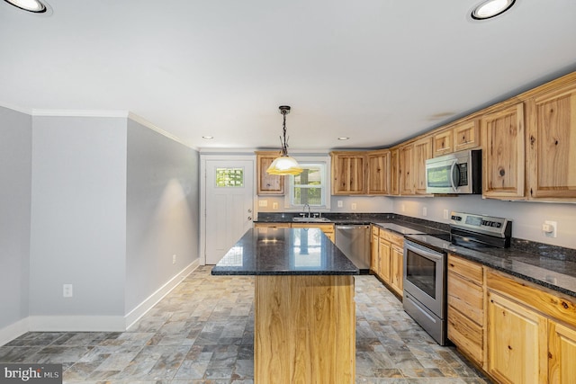 kitchen featuring a kitchen island, stone finish flooring, appliances with stainless steel finishes, baseboards, and ornamental molding