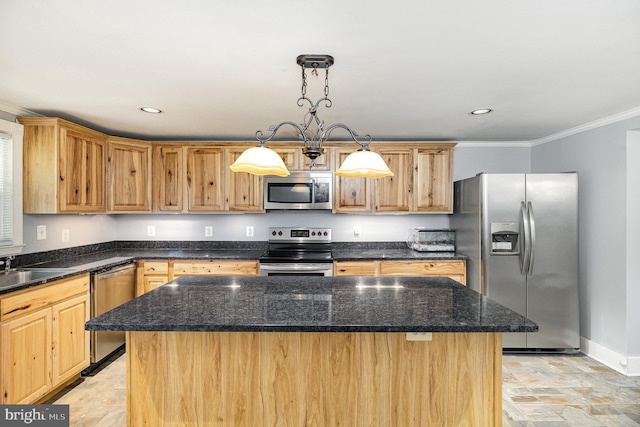 kitchen with stone finish flooring, appliances with stainless steel finishes, a center island, baseboards, and ornamental molding