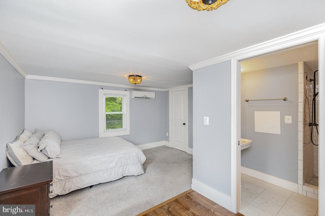 bedroom with crown molding, baseboards, and a wall mounted AC