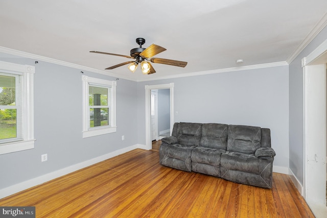 unfurnished living room with baseboards, ceiling fan, wood-type flooring, and ornamental molding