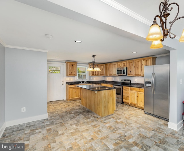 kitchen featuring ornamental molding, a sink, dark countertops, and stainless steel appliances