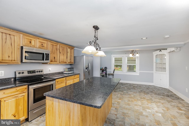 kitchen featuring pendant lighting, a kitchen island, an AC wall unit, stone finish flooring, and appliances with stainless steel finishes