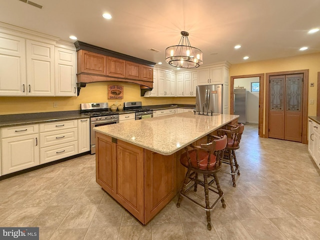 6 Happy Hoof Ln, Ronks, PA 17572 - kitchen featuring dark stone counters, an inviting chandelier, recessed lighting, pendant lighting, and appliances with stainless steel finishes