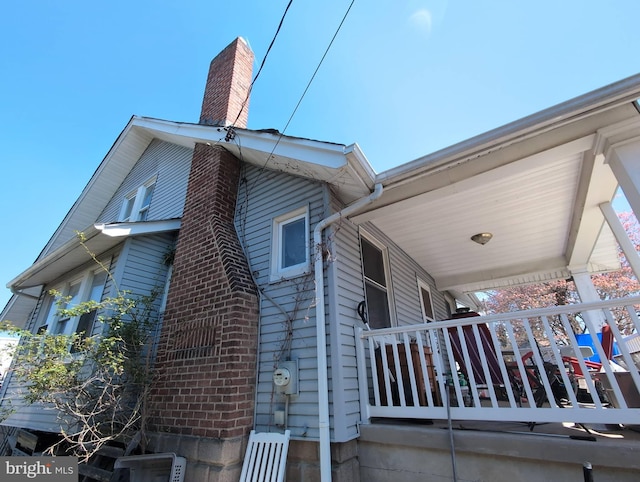 view of side of home with a chimney