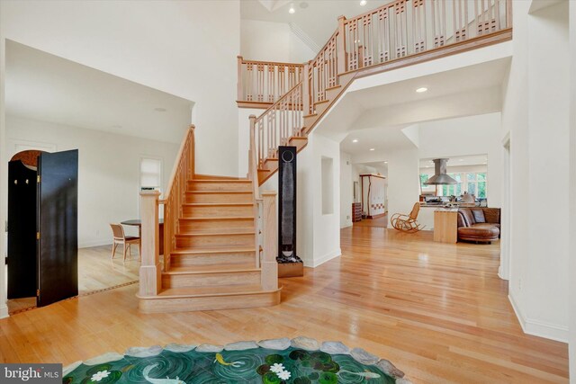 2800 Deer Leap Ln, York, PA 17403 - stairway featuring wood finished floors, a towering ceiling, and baseboards