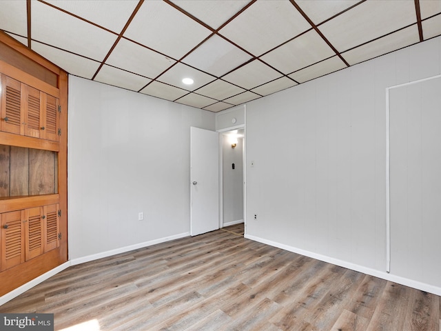 unfurnished room with recessed lighting, light wood-style floors, and baseboards