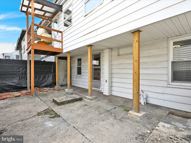 view of patio / terrace featuring fence and a deck
